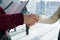 Cropped hands of female colleagues giving handshake