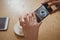 Cropped hands of woman photographing coffee cup