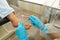 Cropped head portrait of doctor podiatry in blue gloves doing medical treatment on the fingers in medical center