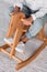 cropped image of african american kid sitting on rocking horse