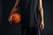 Cropped image of an african basketball player holding ball