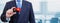 Cropped image of businessman holding plastic credit card with printed flag of Papua New Guinea. Background blurred