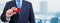 Cropped image of businessman holding plastic credit card with printed flag of Tonga. Background blurred