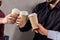 cropped image of businessmen clinking with disposable coffee cups