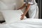 Cropped image of a chambermaid making bed in hotel room