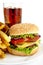 Cropped image of cheeseburger,french fries,glass of cola on plat