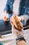 cropped image of chef giving tasty hot dog to customer in food truck