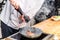 cropped image of chef seasoning frying meat