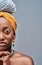 Cropped image close up of half african woman face looking at camera isolated over grey background