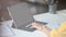Cropped image of creative woman holding a stylus pen while drawing/pointing on white blank screen computer tablet.