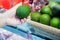 Cropped image of a customer choosing avocados in the supermarket. close up of woman hand holding avocado in market.