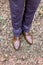 Cropped image of elegant shoes of stylish groom in suit standing in the forest. Stylish wedding grooms photo