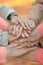 Cropped image, family putting hands together close up