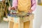 cropped image of female artist applying paints on palette