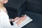 cropped image of female counselor writing in empty clipboard during therapy session