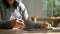 Cropped image of a female using her tablet while relaxing in the cozy coffee shop