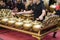 Cropped image group of gamelan orchestra playing harmonic song,