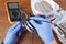 Cropped image of hands examining thermal fuse of electric fan heater with multimeter.