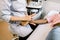 Cropped image of hands of female doctor with ultrasound scanner conducting ultrasound examination of wrist of young