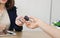 Cropped image of hands of sales car dealership giving keys to customer