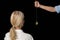 Cropped image of hypnotherapist holding pendulum by woman