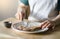 Cropped image of kid hands spreading butter on bread, Child applying butter to toast for his breakfast Kid is preparing food ,