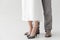 cropped image of legs of couple of models in linen dress and trousers