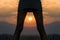 Cropped image legs of young woman silhouette at sunset