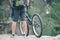 cropped image of male cyclist with backpack standing