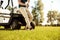 Cropped image of a male golfer leaning on a golf cart