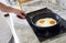 Cropped image of man cooking scrambled eggs on frying pan