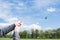 cropped image of man flying kite on meadow