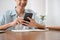 Cropped image, A man reply a message on the phone, using his smartphone at his desk