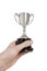 Cropped image of man\'s hand holding winning trophy over white background