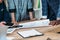 cropped image of multicultural businesspeople near table with documents and gadgets