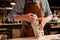 Cropped image of a shoemaker measuring a shoe