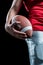 Cropped image of sportsman holding American football