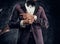 Cropped image of a stylish bearded man dressed in a violet elegant suit standing against a dark textured wall