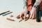 cropped image of tattooed barber putting equipment on table