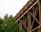 Cropped image of Train Tracks Support of bridge with green tree brush