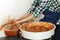 Cropped Image of Unrecognizable Female Ceramics Maker working with Pottery Wheel in Cozy Workshop Makes a Future Vase or