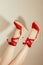 cropped image of upside down female feet in stylish red platform sandals