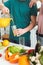 cropped image of vegan boyfriend pouring fresh juice into glass in kitchen