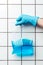 cropped image of woman in blue rubber glove holding ziplock plastic bag with blue water, earth