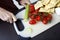 Cropped image of woman chopping cucumber at kitchen counter