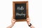 Cropped image of woman hands holding chalkboard with lettering hello monday on white