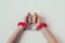 cropped image of woman hands in red fluffy handcuffs on white, valentines
