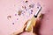 cropped image of woman holding bottle of champagne above confetti on party table