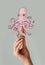 Cropped image of woman holding waffle ice cream cone with octopus