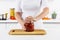 cropped image of woman opening glass jar with preserved tomatoes